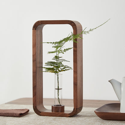 Clear glass flower vase with plant