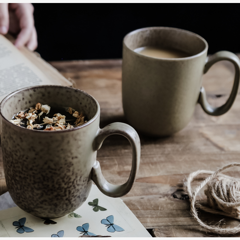 Simple retro ceramic mug on table with coffee