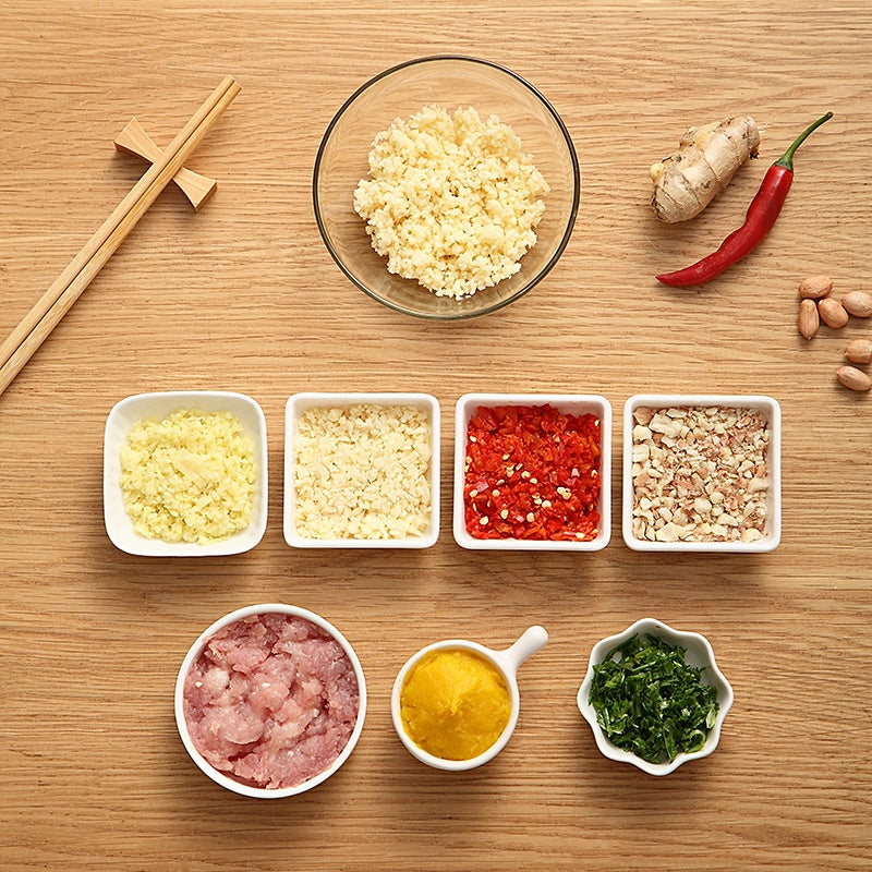 Minced garlic, chilli, nuts and herbs in small bowls