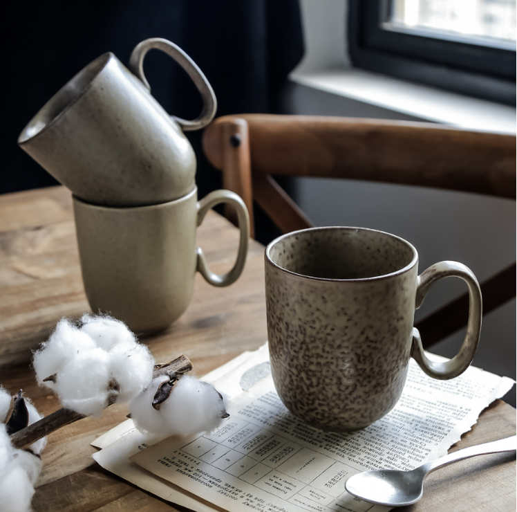 Simple retro ceramic mug in dark brown, front view