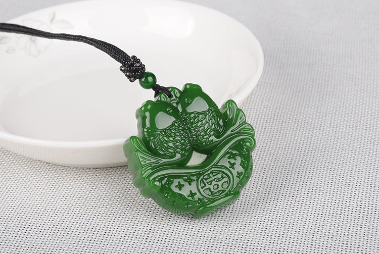 Hetian jade fish pendant symbolizing abundance, front view