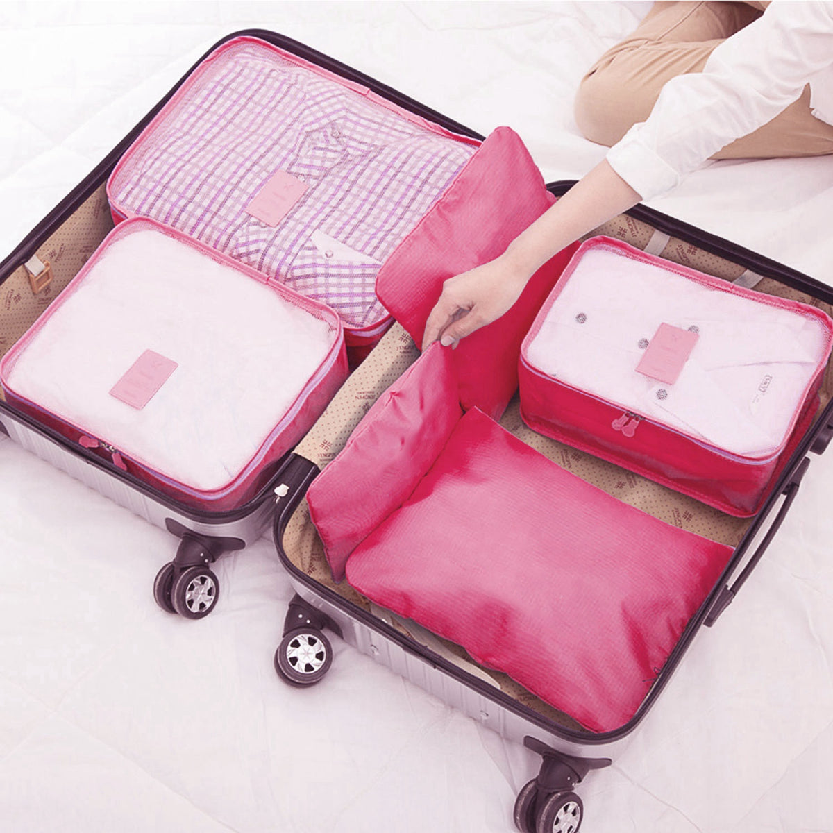 Packing cubes and pouches arranged inside an open suitcase