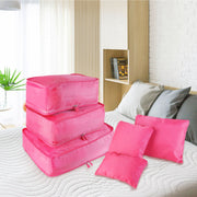 Hot pink packing cube set on a bed: three cubes and three zip pouches